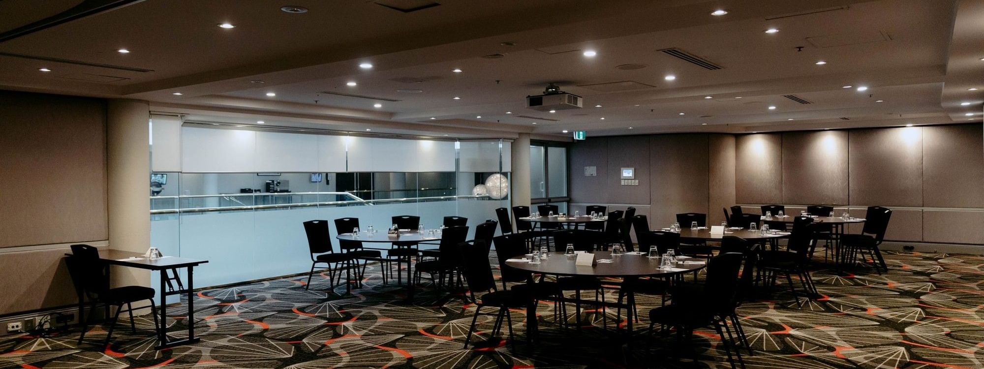 Linden Room event space with round tables and chairs at Novotel Sydney Parramatta