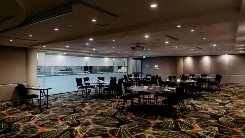 Linden Room event space with round tables and chairs at Novotel Sydney Parramatta.