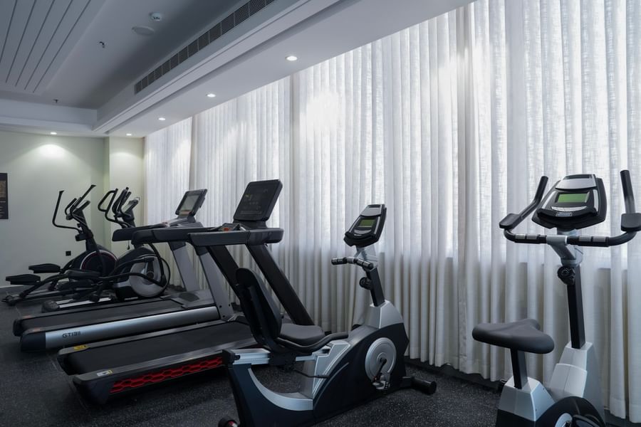 Four treadmills and two stationary bikes in a gym at Warwick Hotel & Spa - Jeddah.