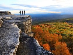 Mountain cliff overlooking fall trees