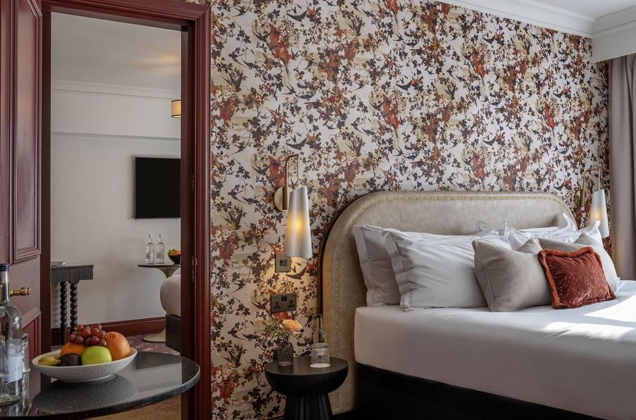 Bed with side tables near mirror in Superior King at The Capital Hotel, Apartments and Townhouse