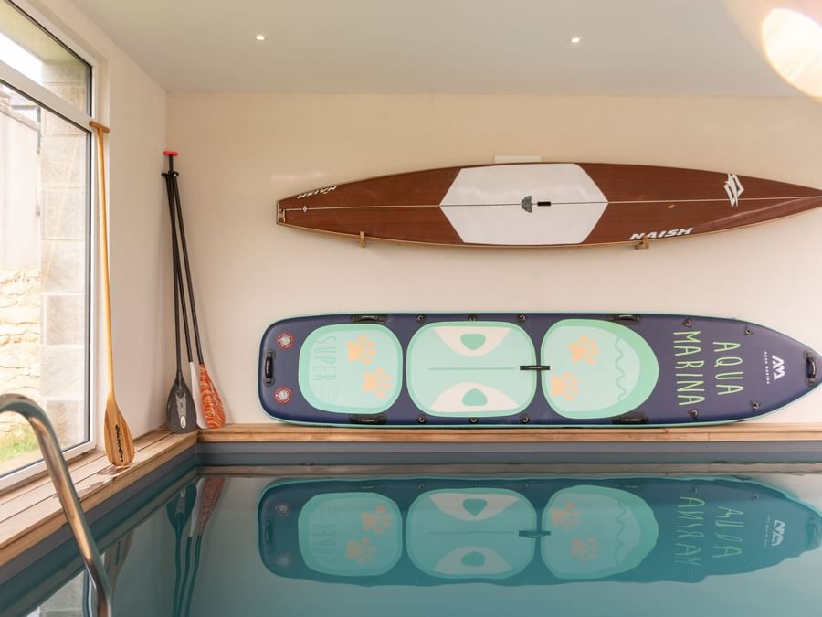Indoor pool with hanged kayaks at The Originals Hotels