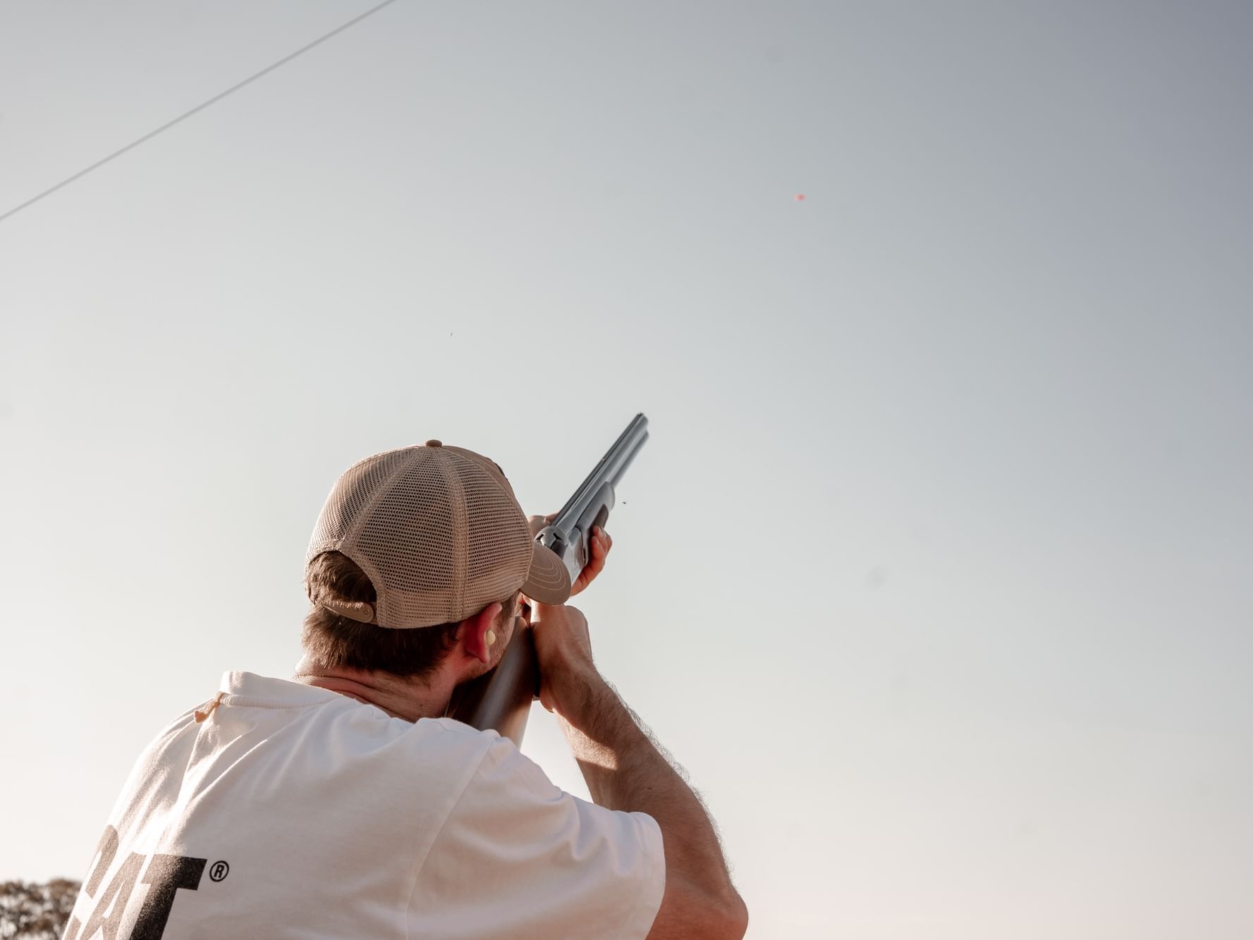 Close-up of man pointing a gun to the sky near Hotel Jackson