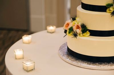 A closeup of a Wedding cake and Candle The Venue at Portwalk