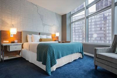 Bed & a nightstand in One Bedroom Suite at Kinzie Hotel