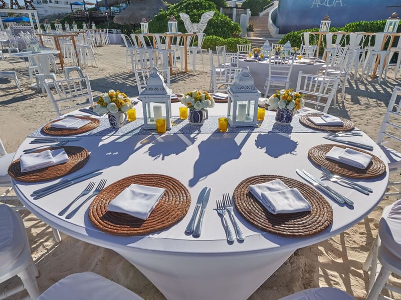Close-up of a banquet table with culinary on sandy shore at Live Aqua Resorts and Residence Club