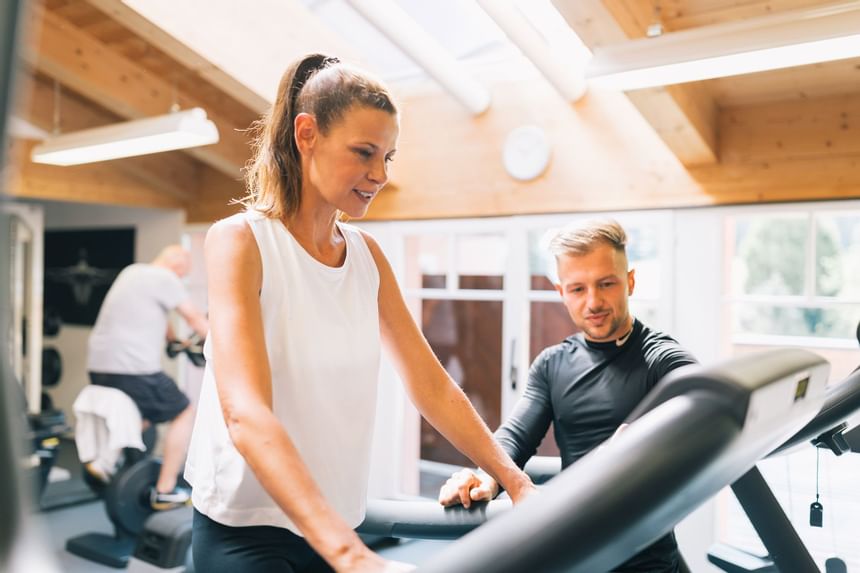 Gym trainer instructing a lady in a gym at Liebes Rot Flueh