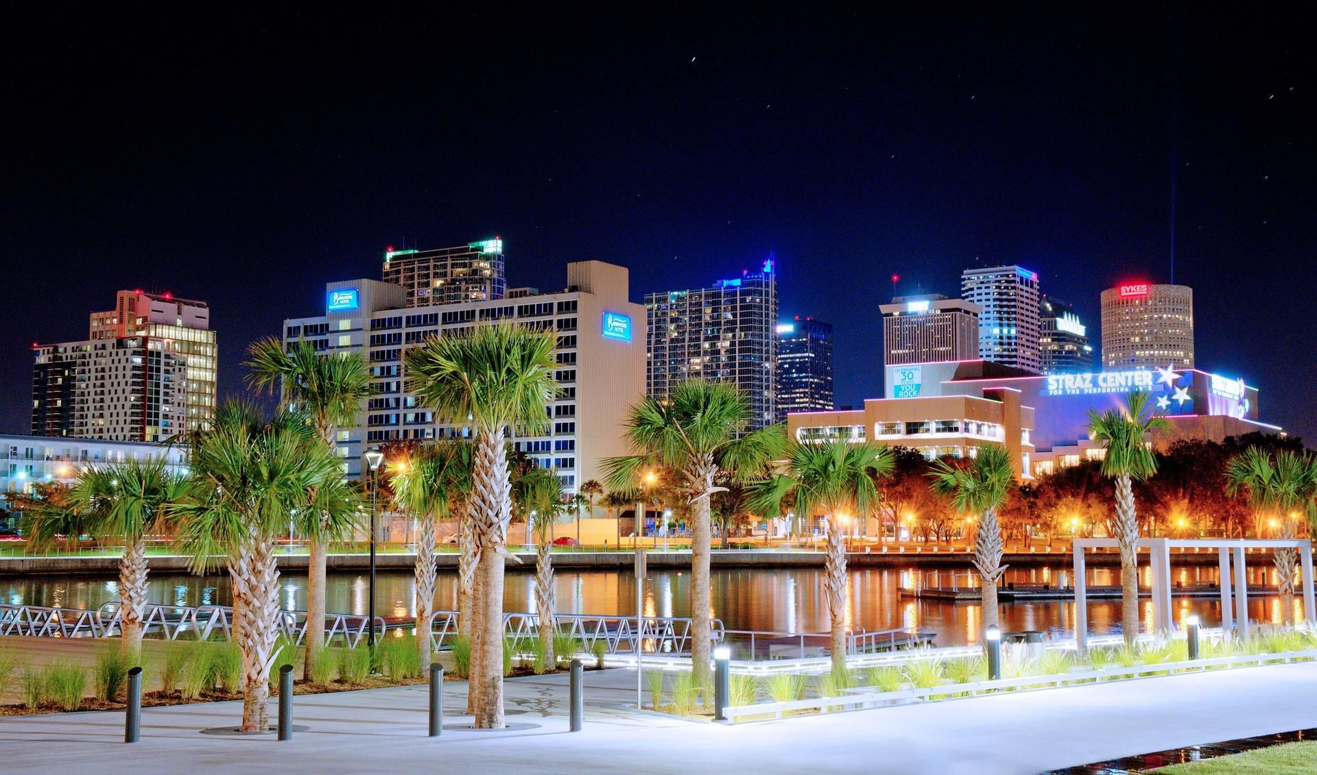 Illuminated city skyline & river at night near The Barrymore Hotel