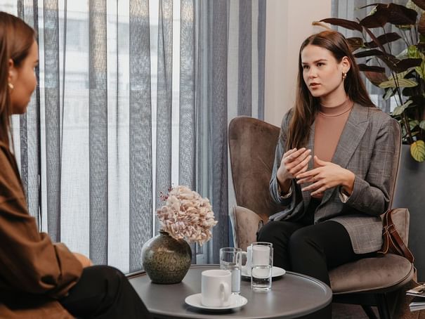 Two girls conducting a meeting in a room at Hotel Berlin Berlin