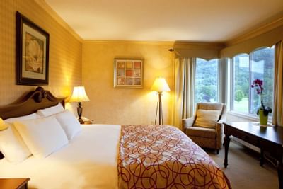 Bed with dining table in Standard Room at Honor’s Haven Retreat