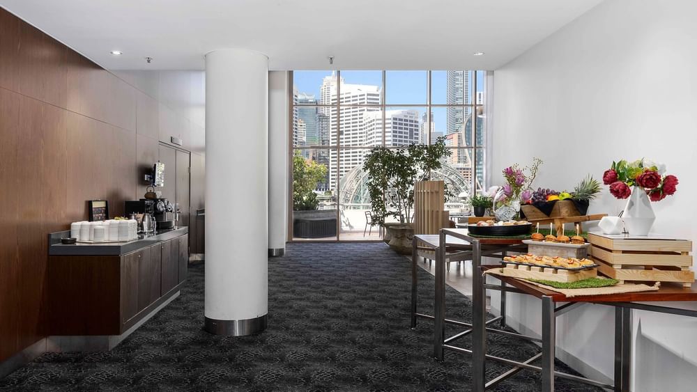 The Hunter Room 3 interior with refreshments, city views, and a large window at Novotel Sydney on Darling Harbour