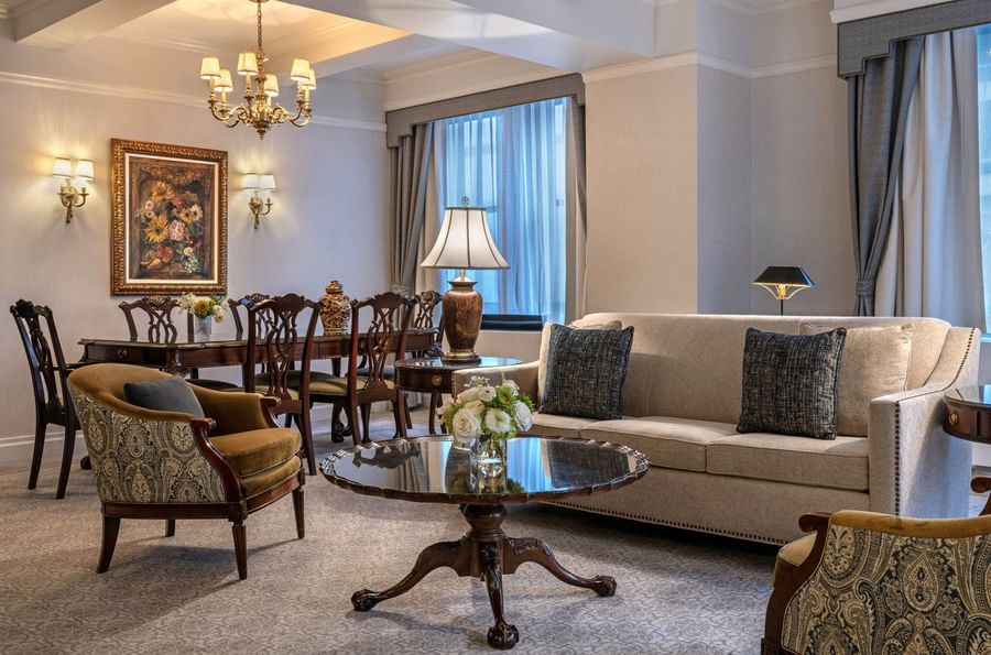 Elegant living room with a couch, chairs, coffee table, and dining set at Warwick New York.