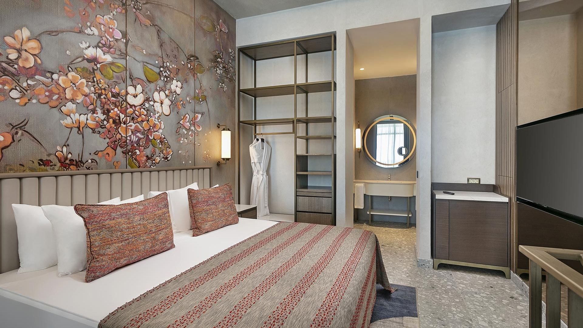 TV facing the bed in Superior Duplex Swim-up with floral wall art at Cullinan Belek