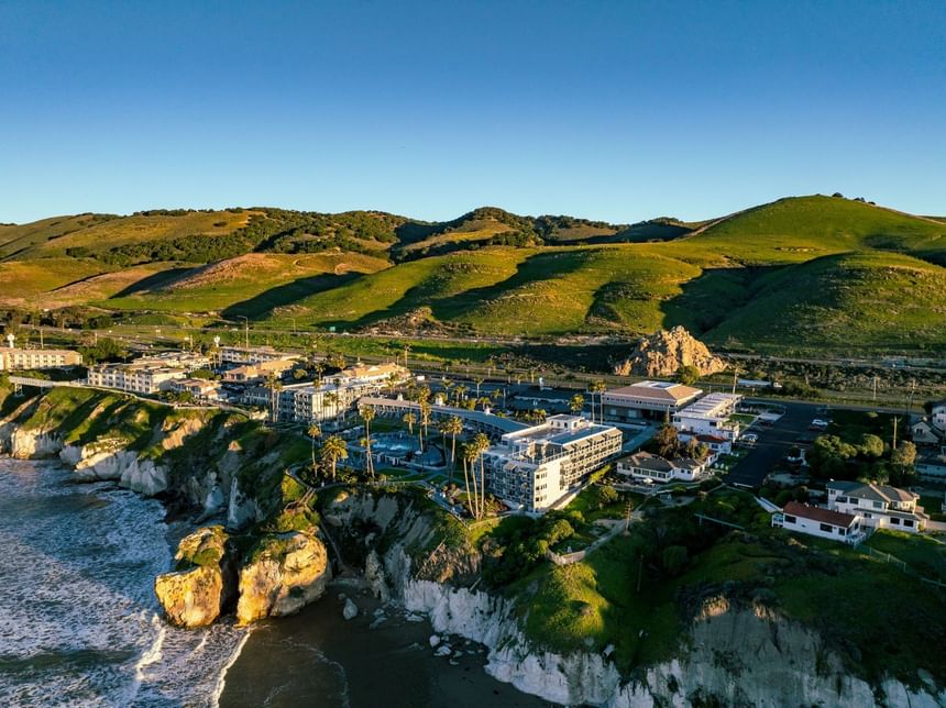 Aerial view of Pismo bluffs with hotels and Pismo Preserve 