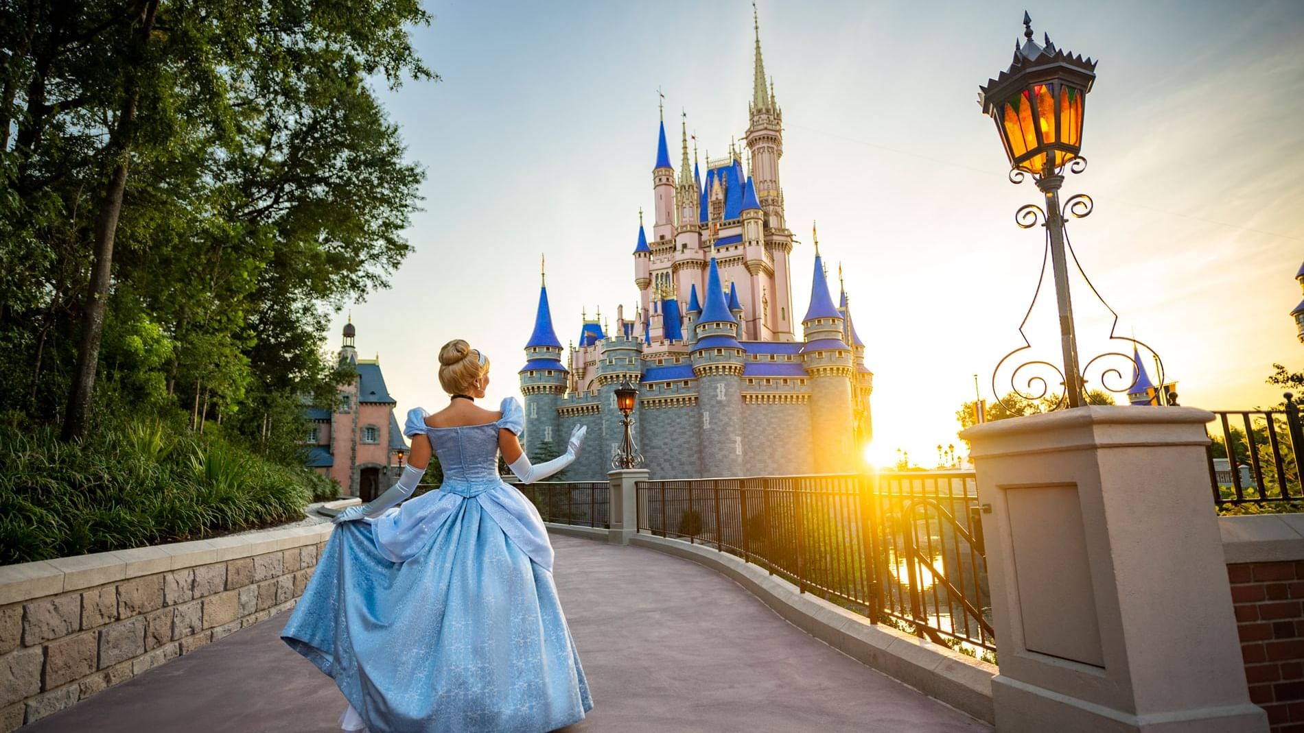Cinderella character posing in front of castle at sunset near Lake Buena Vista Resort Village & Spa
