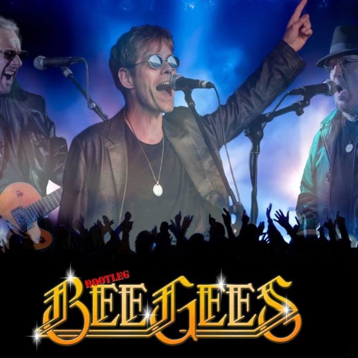 The Bootleg Bee Gees performing live at The Milner York to a crowd with their hands raised