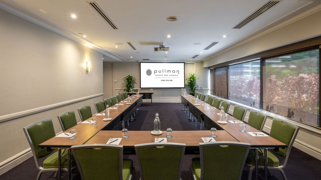 U-shape table set-up with projector screen in Parkview Room at Pullman Sydney Hyde Park