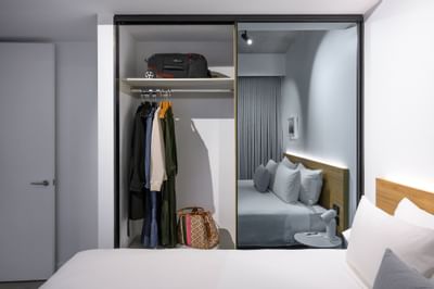 Wardrobe with clothes in a Room at Nesuto Docklands