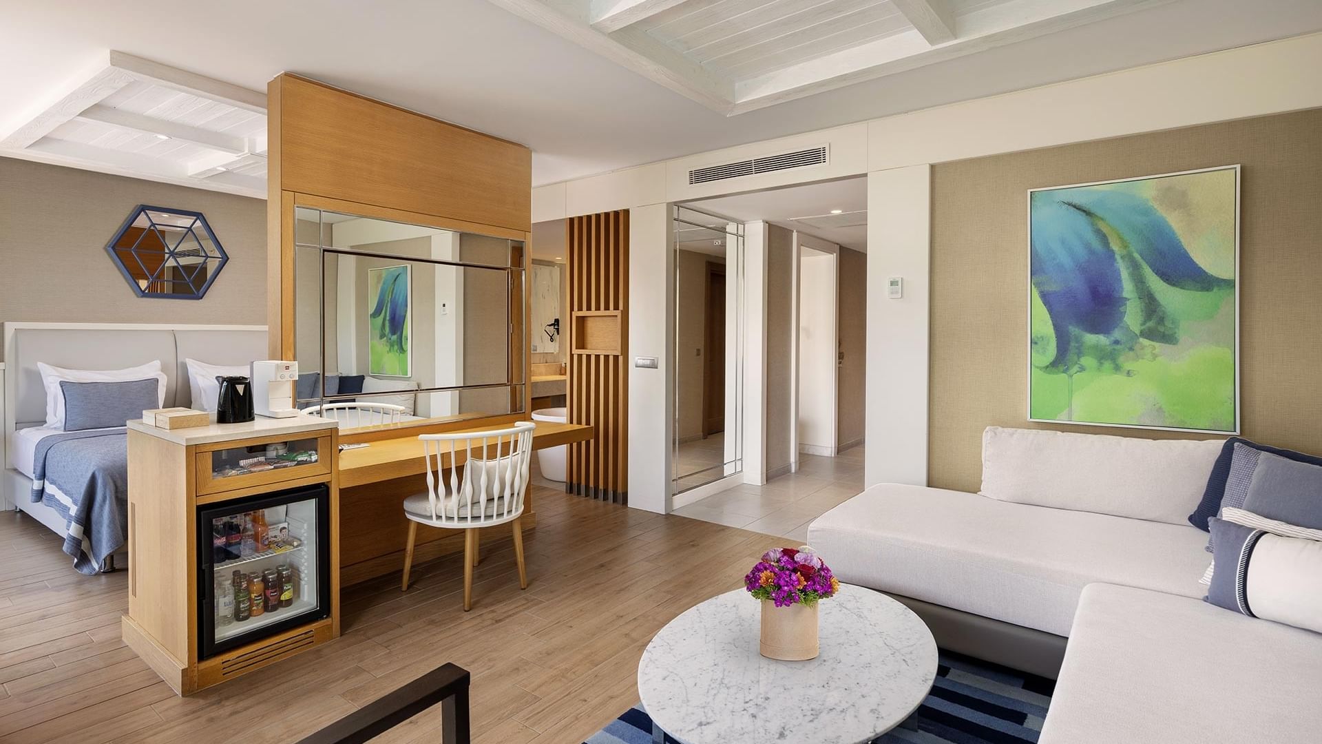 Living room area with modern furniture in Swim-up Deluxe Room at Titanic Luxury Collection Bodrum