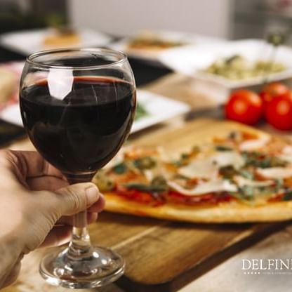 Pizza and wine served at restaurants in Lima at Delfines Hotel