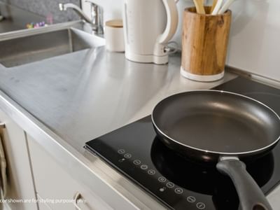 Frying pan on a black induction stove at Mayoral Drive Student Accommodation.