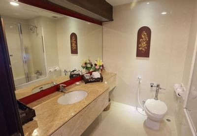 Vanity area with large mirror in Deluxe Room at Amora Hotel