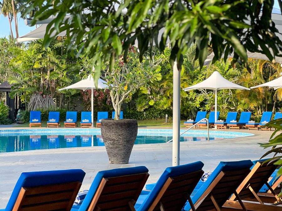 Lounge chairs surround the swimming pool at The Naviti Resort in Korolevu