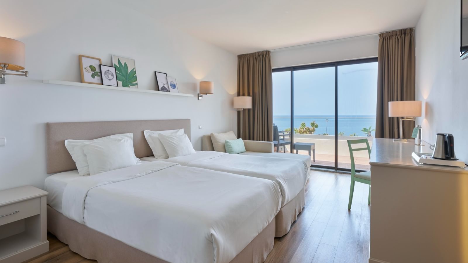 Workspace facing the cozy beds in Classic Ocean View with wooden flooring at Bensaude Hotels