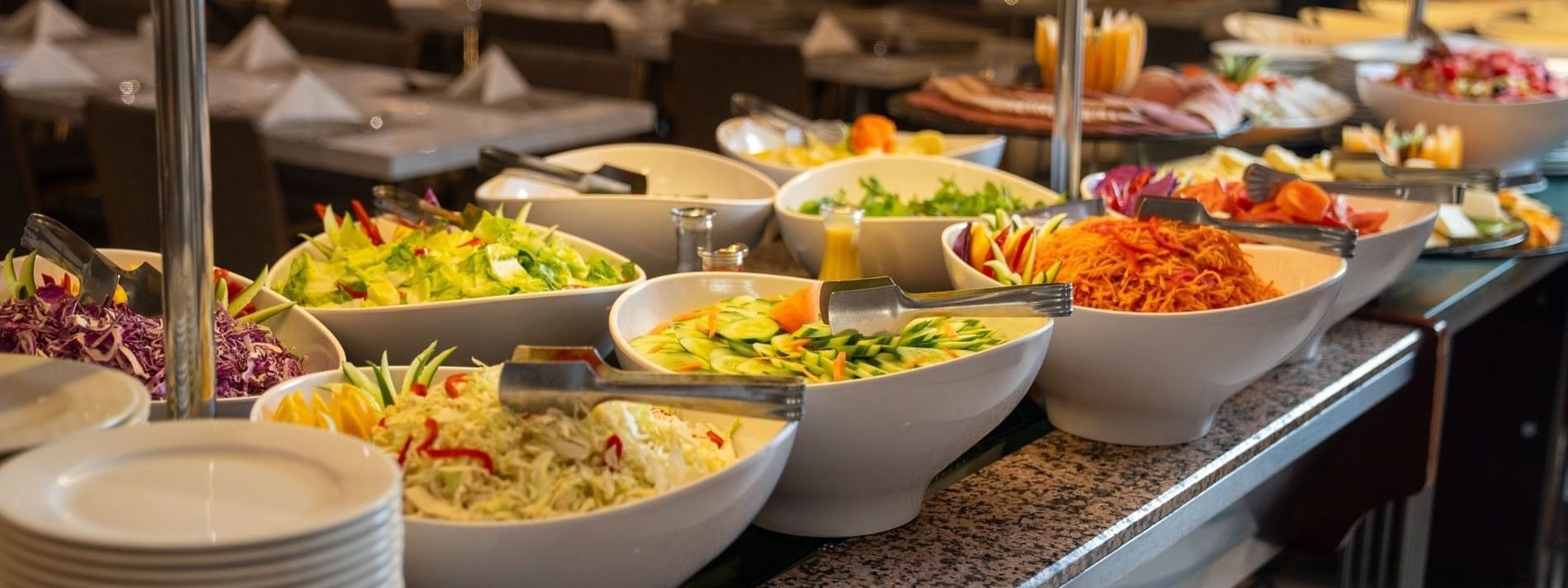 Variety of fresh colorful salads in large bowls in AI Firdous restaurant at Saja Warwick Madinah