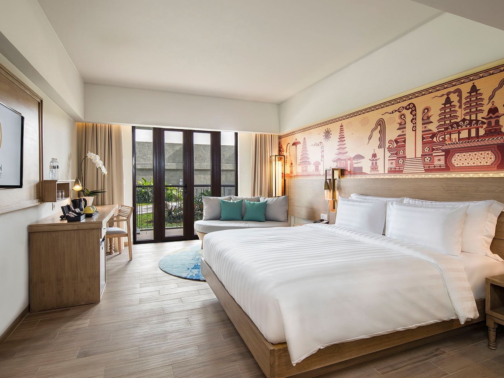 Cozy bed with TV area in Superior Room at Eastin Ashta Resort Canggu