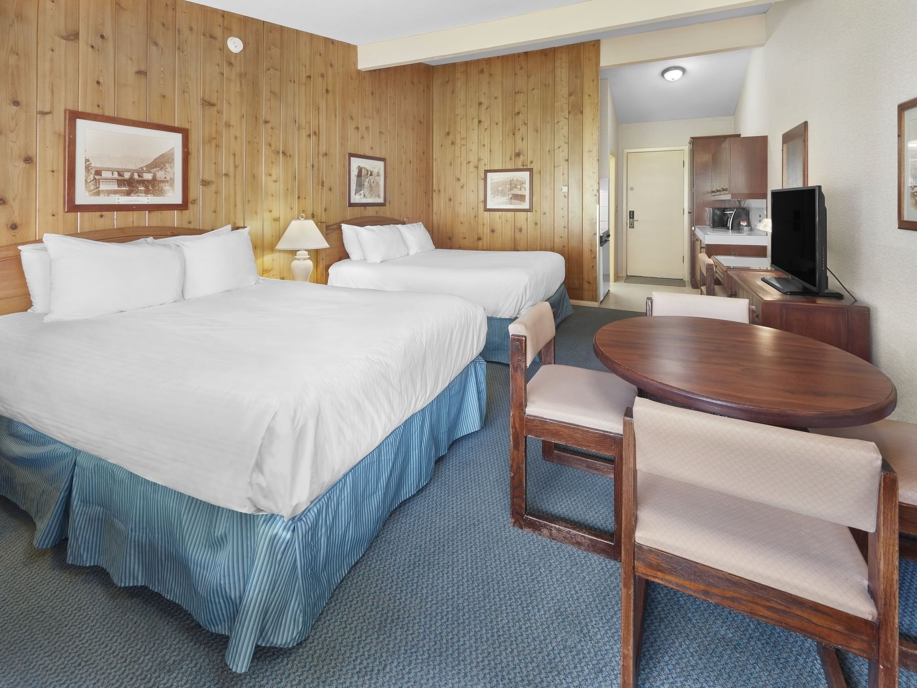 Cozy beds and a table in Juniper Standard with Kitchenette at Fairmont Hot Springs Resort