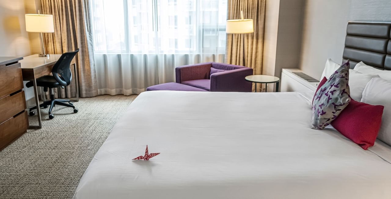 Hotel room with bed, couch, and work desk