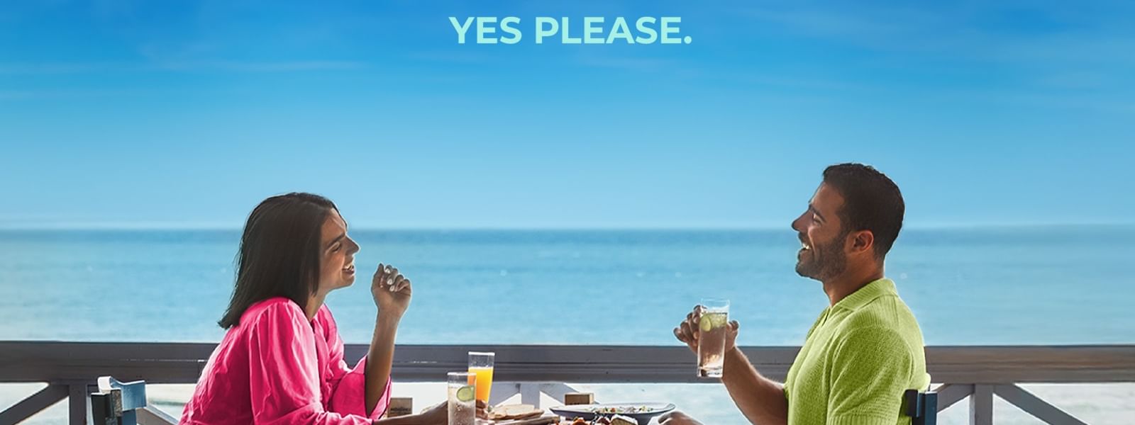 Couple dining at a beachside table with ocean view, triple the points offer.