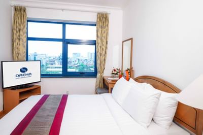 Room with comfy bed, dressing table, TV at Hanoi Daewoo Hotel