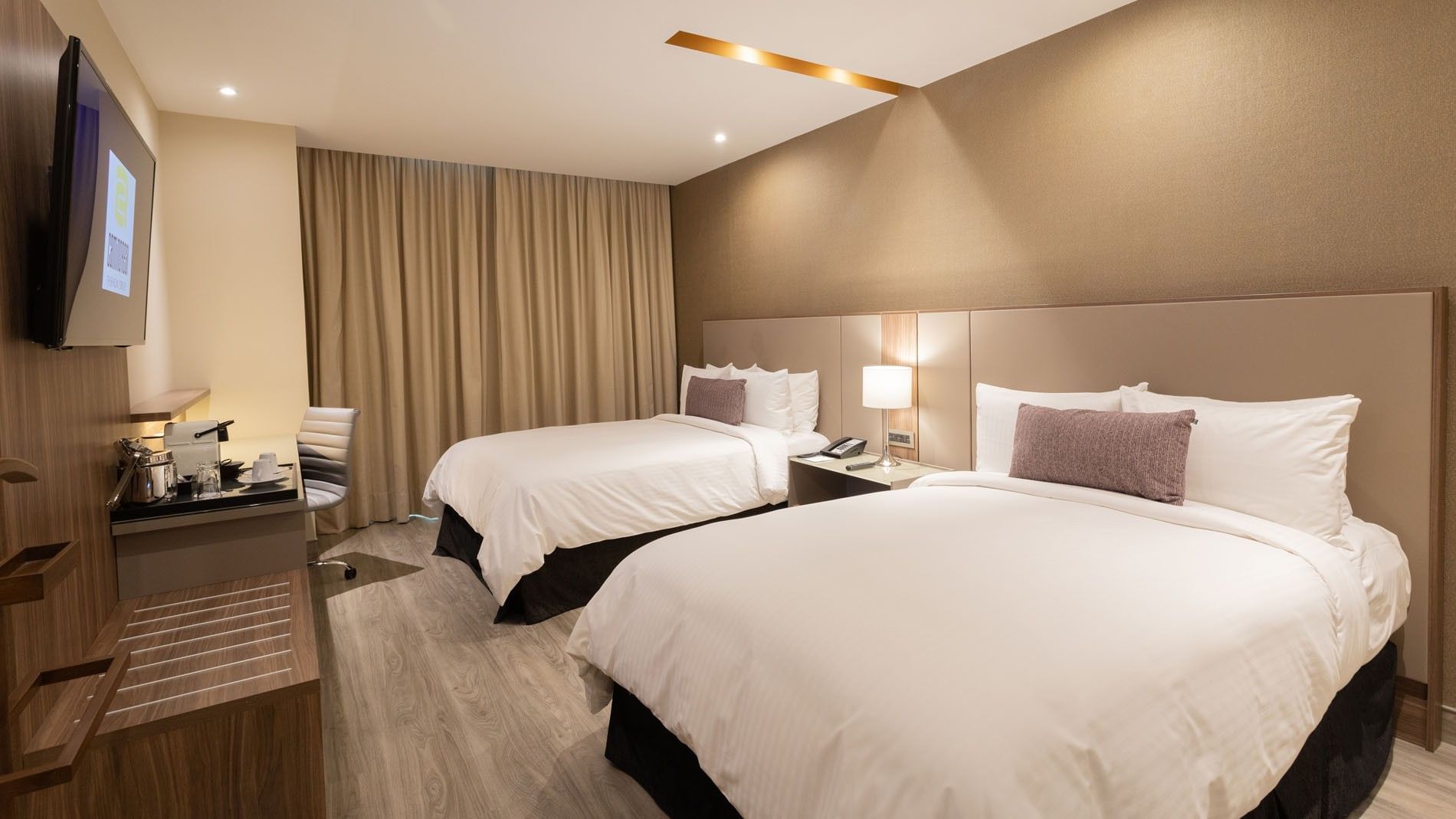2 Double Deluxe Superior Beds with two beds, and a sleek wooden desk at Camino Real Fashion Drive, Monterrey