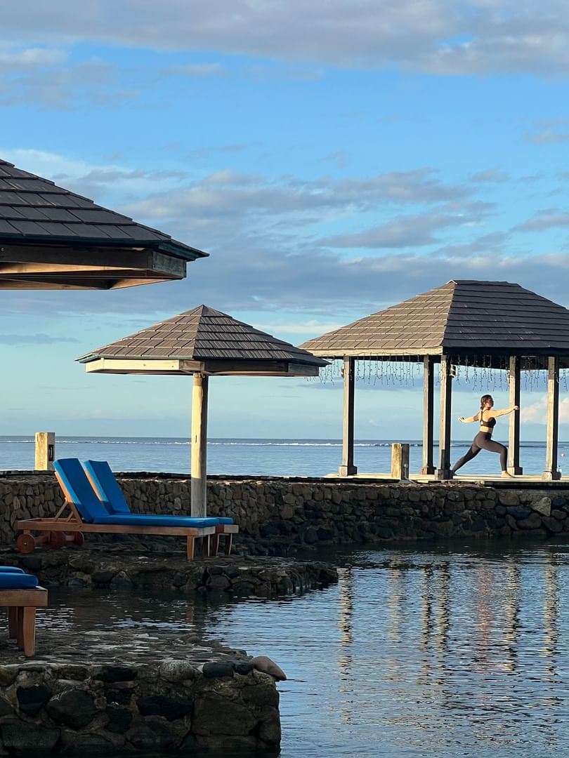 Woman doing yoga on platform at Warwick Fiji Resort and Spa in Korolevu