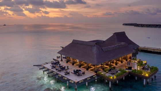 Aerial view of overwater Firedoor with a thatched roof at Grand Park Kodhipparu, Maldives