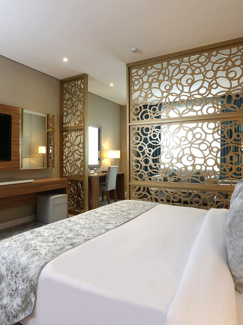 Elegantly furnished Junior Suite with modern decor and amenities at Cantonal Hotel by Warwick Riyadh.