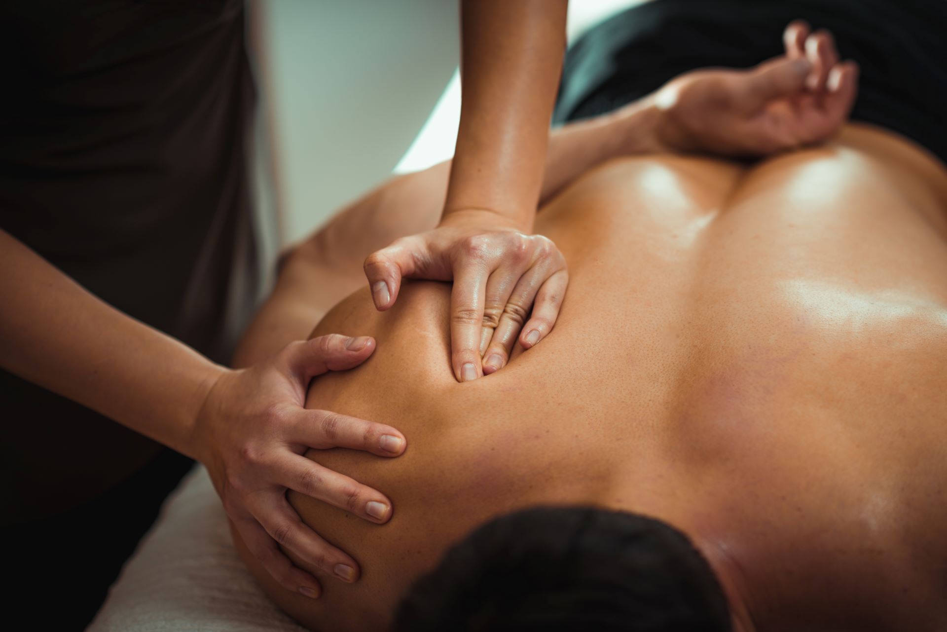 A man receiving a relaxing oil massage from a therapist at Cove Pocono Resorts