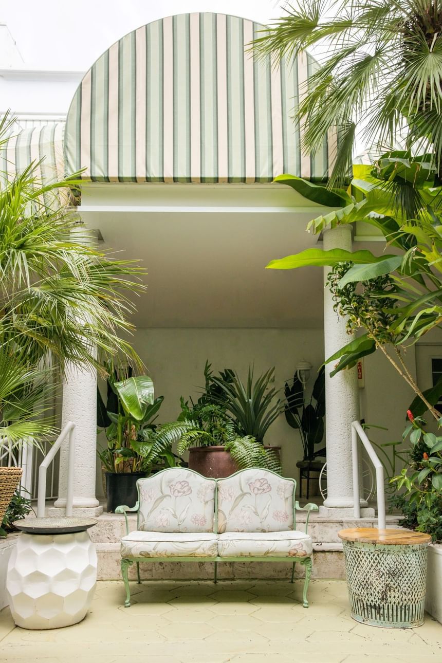 A white couch on the porch in Garden at The Savoy On South Beach