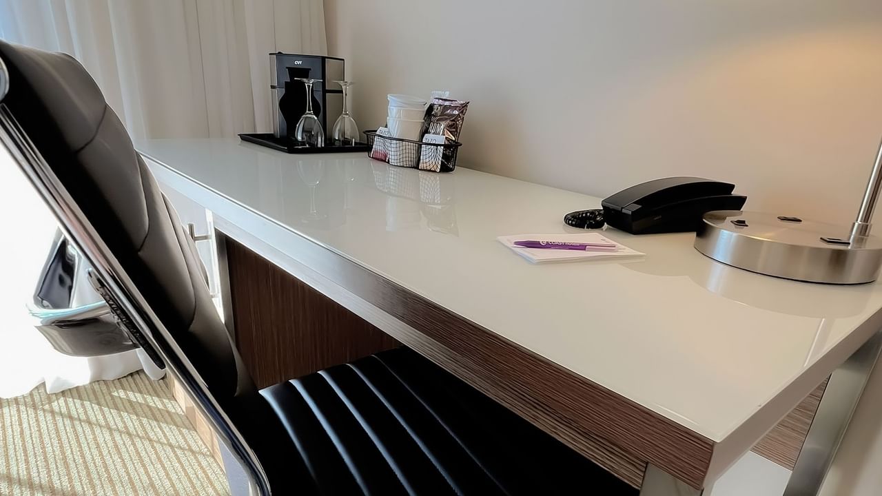 Desky with chair, lamp, phone, coffee station