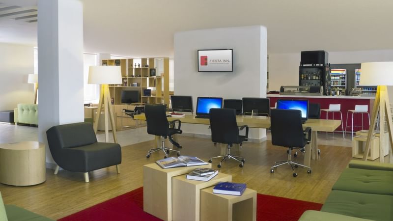 Desktop computers set up on a table at Fiesta Inn León