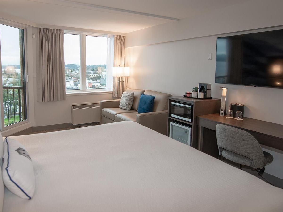 King bed with city view in Coast King room at Coast Bastion Hotel in Nanaimo.