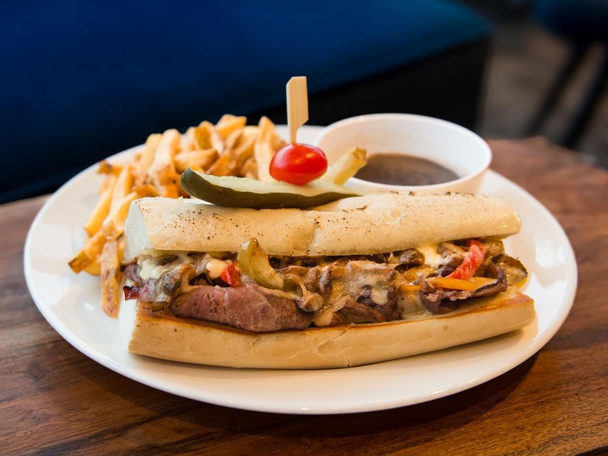 Steak sandwich with fries and sauce at Minnoz Restaurant + Lounge, Coast Bastion Hotel in Nanaimo.