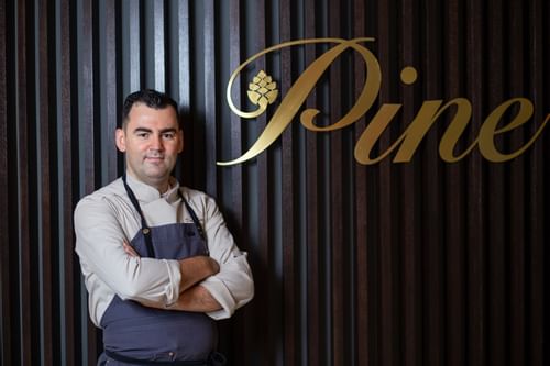 A chef in Pine Restaurant & Terrace at Crowne Plaza Bucharest