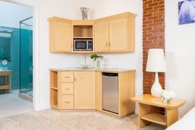 Kitchenette with pantry, dishwasher & microwave oven in King Premiere Sky at Retro Suites Hotel