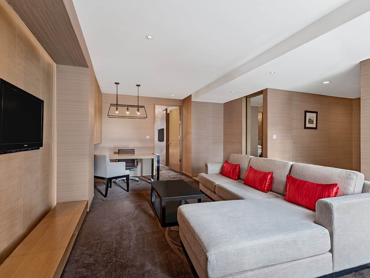 Executive Suite at Paradox Bangkok, with a sofa by a work desk under a metal light fixture, featuring Sukhumvit accommodation