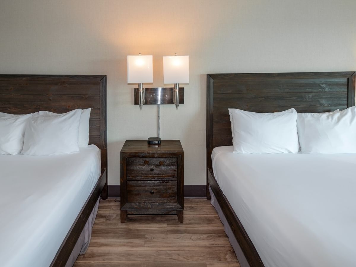 Coast Two Queens two queen beds, a nightstand with lamps, and wooden floor at Coast Lonsdale Quay Hotel
