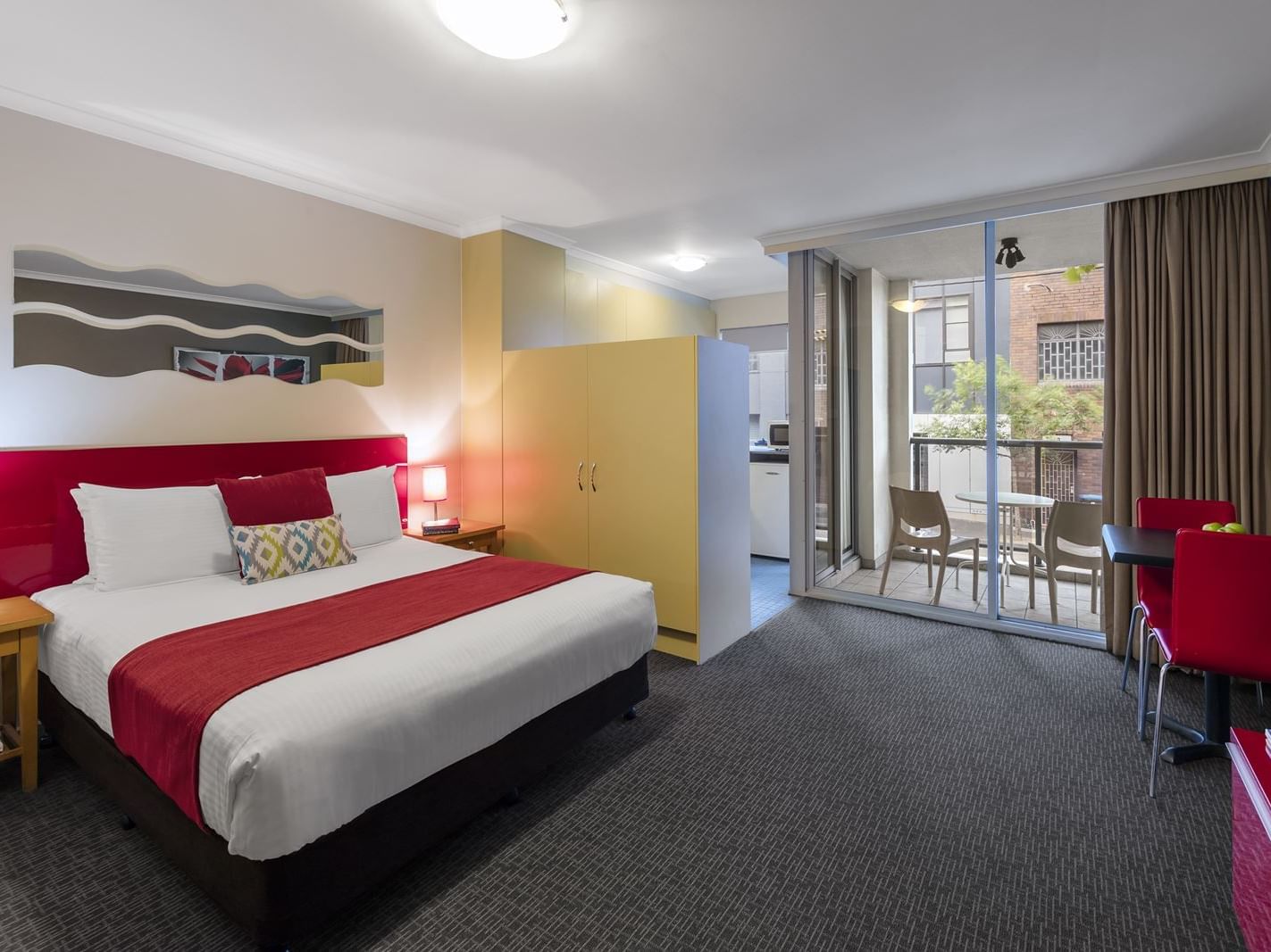 King bed with headboard in Studio Apartment at Nesuto Hotels