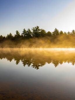 Landscape view of the sunrise hitting across the waters near Cove Pocono Resorts